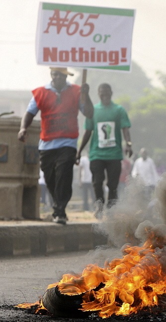 Lagos: Demonstrators holding a placard which reads 'N(aira) 65 or nothing' burn tyres and protest in Lagos against the government's decision to remove a popular fuel subsidy. 