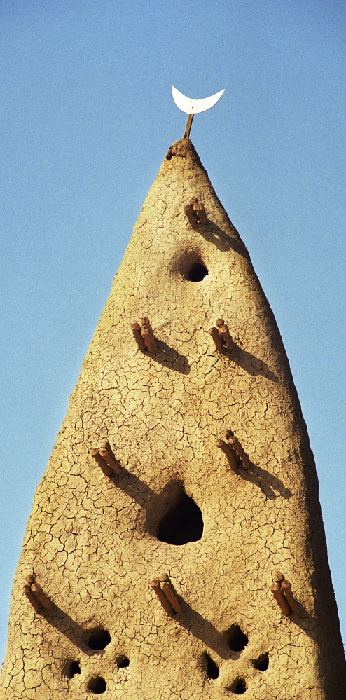 Mali: Minaret of a mud mosque. Each year the mosque is given a new layer of clay to replace what the rains have washed away. Dieter Telemans / Panos