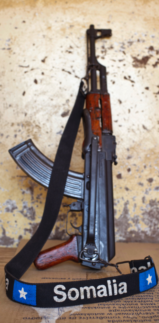 Gaalkaayo, Puntland. An AK47 rifle with a strap embroidered with 'Somalia' leans against a wall. Sven Torfinn / Panos