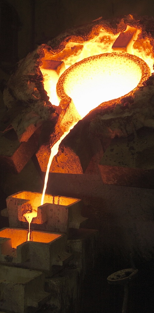 GHANA Obuasi: Gold pouring into moulds that form gold bars. Jacob Silberberg / Panos
